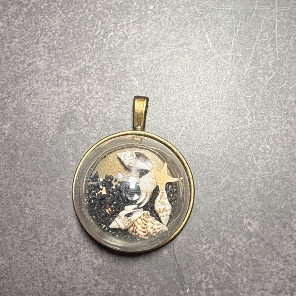 Gold Pendant with Seashell Design
